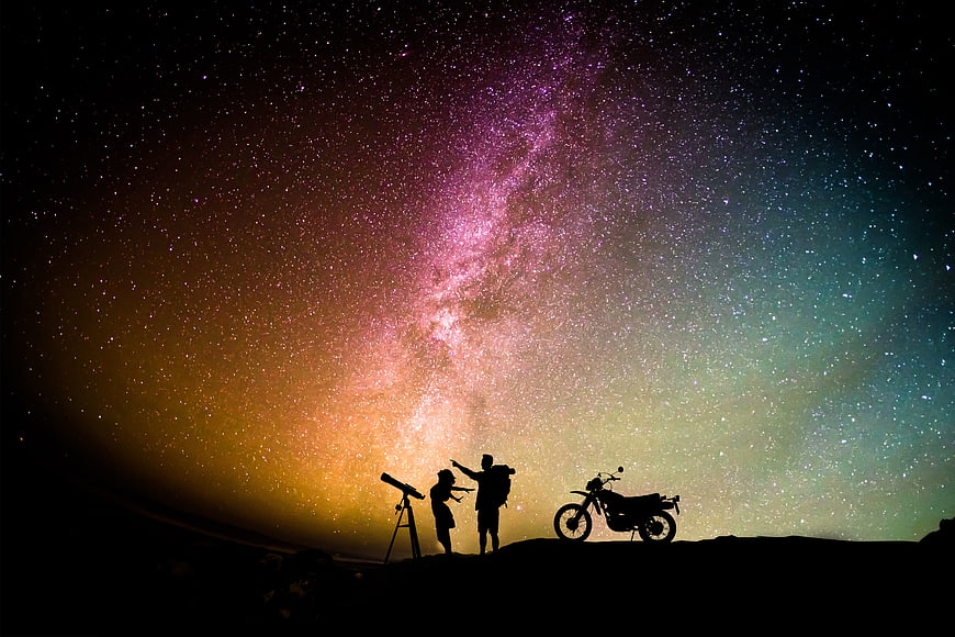 Couple Silhouette Stargazing Under Milky Way with Motorcycle