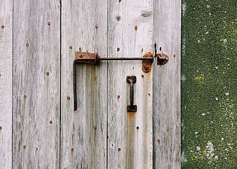 Weathered Wooden Door with Rusty Metal Latch and Handle