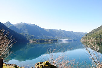 Serene Mountain Lake Landscape with Reflections and Mist