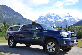 Blue Park Ranger Truck in Mountain Landscape