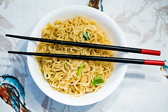Top View of Instant Noodles with Chopsticks in White Bowl