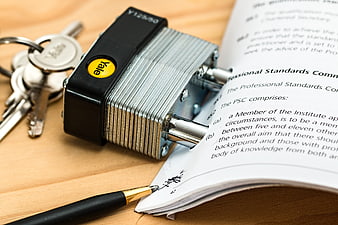 Yale padlock securing legal contract document with pen