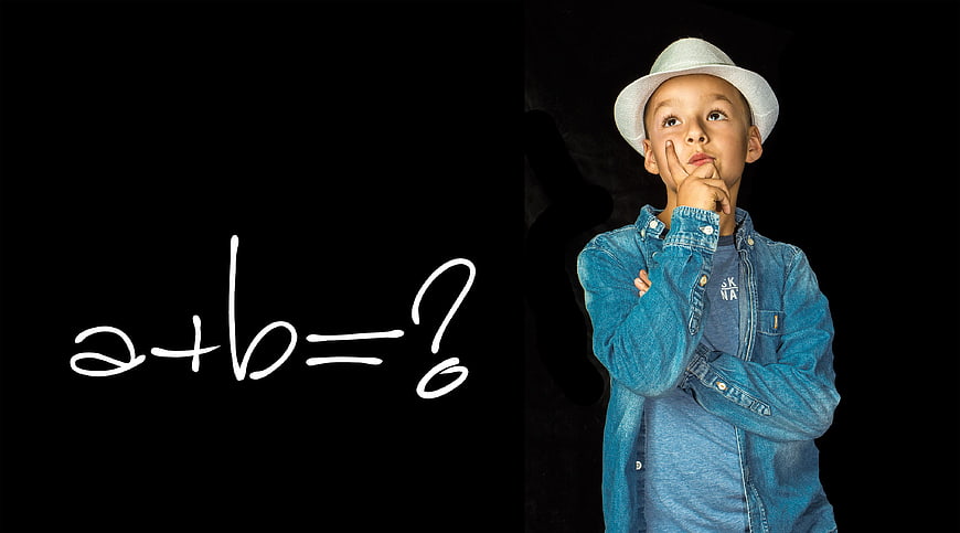 Young boy thinking about math equation on black background