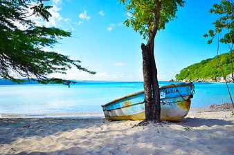 Weathered Blue Fishing Boat on Tropical Sandy Beach