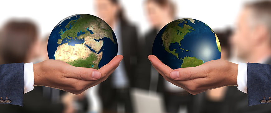 Businessmen Holding Earth Globes Representing Global Partnership
