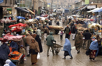 Crowded Afghan street market scene with vendors and shoppers