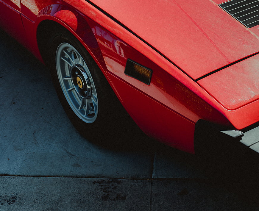Close-up of Classic Red Sports Car Wheel and Body