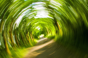 Abstract swirling green forest tunnel motion blur background