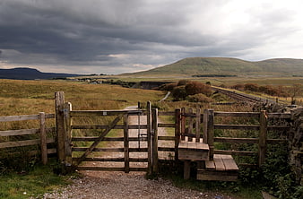 Rural Landscape with Wooden Gate and Rolling Hills