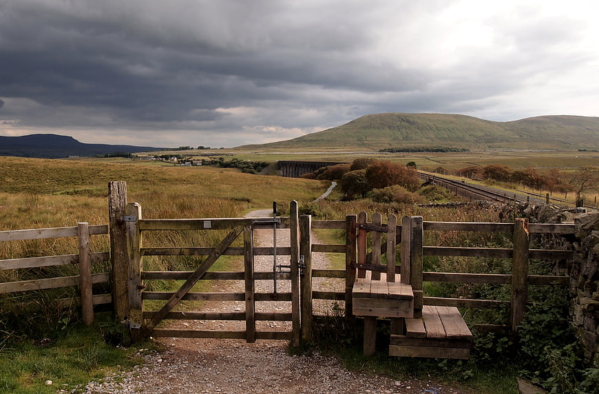 Rural Landscape with Wooden Gate and Rolling Hills