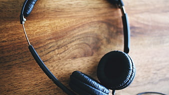 Black headphones on wooden table