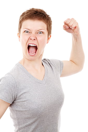 Angry woman screaming with raised fist on white background