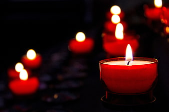 Red Tea Light Candles in Dark Church Setting