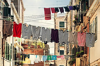 Colorful laundry hanging on lines between old European buildings