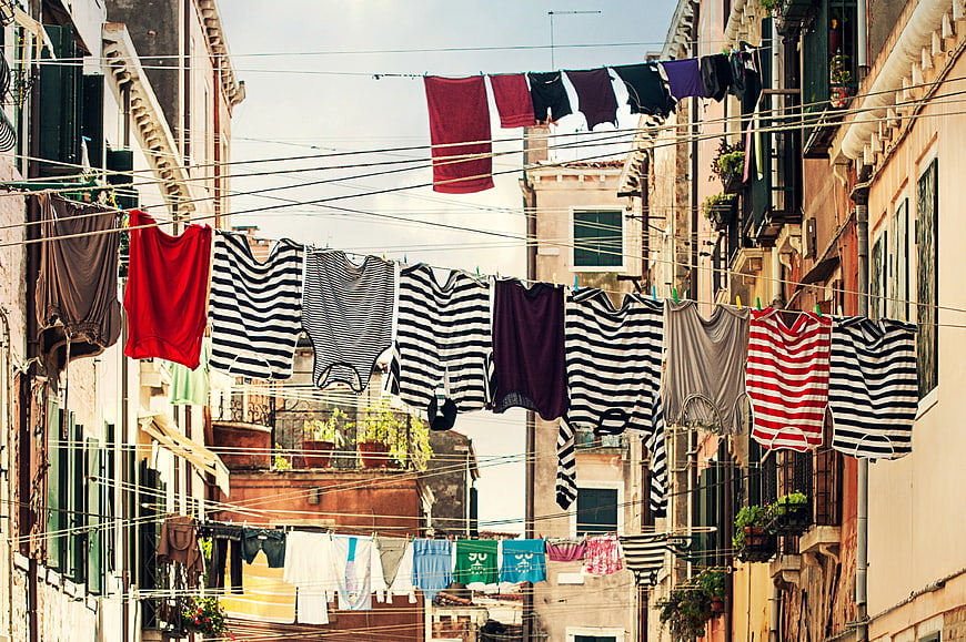 Colorful laundry hanging on lines between old European buildings
