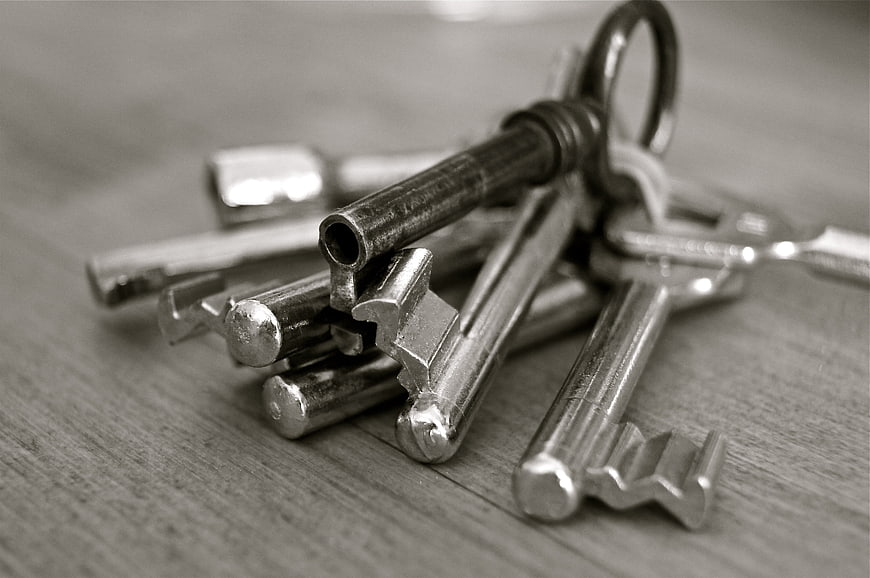 Vintage metal keys on wooden surface black and white
