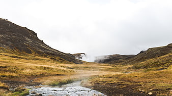 Misty Highland Stream in Rugged Mountain Valley