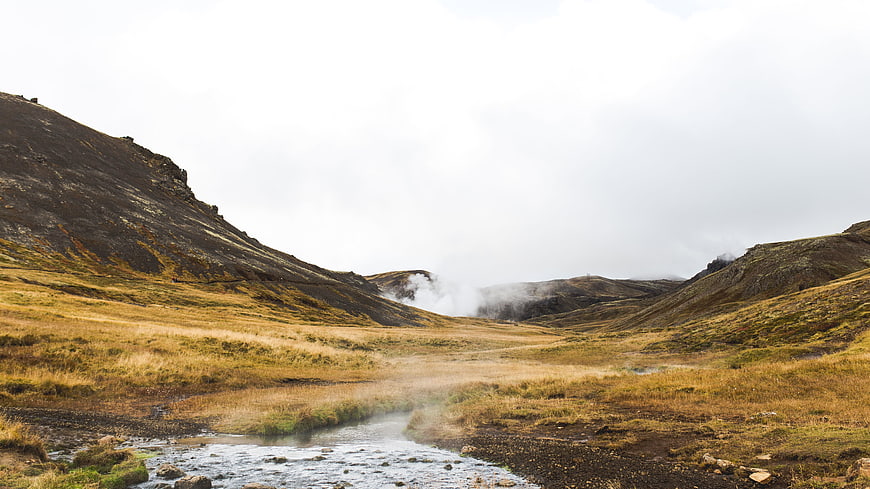 Misty Highland Stream in Rugged Mountain Valley
