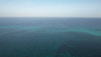 Aerial View of Calm Blue Ocean with Coral Reef Patterns