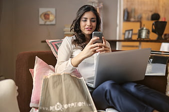 Woman online shopping on laptop and smartphone at home