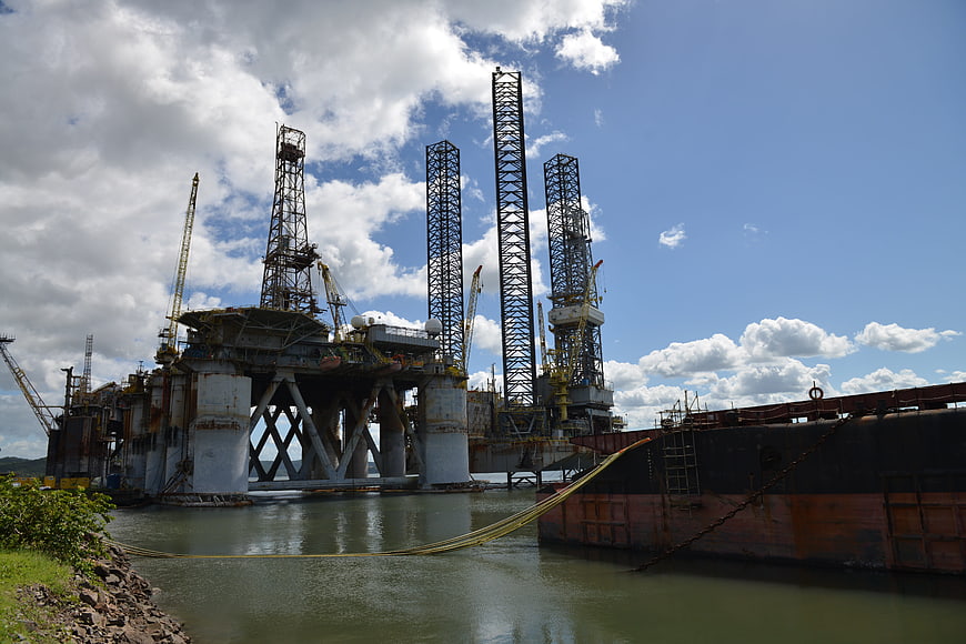Large offshore oil rig platform docked in river