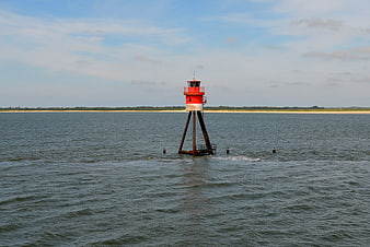 Red and white navigational daymark buoy in the North Sea