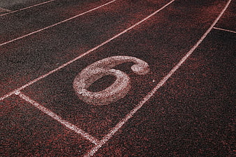 Close-up of number 6 on red running track lane