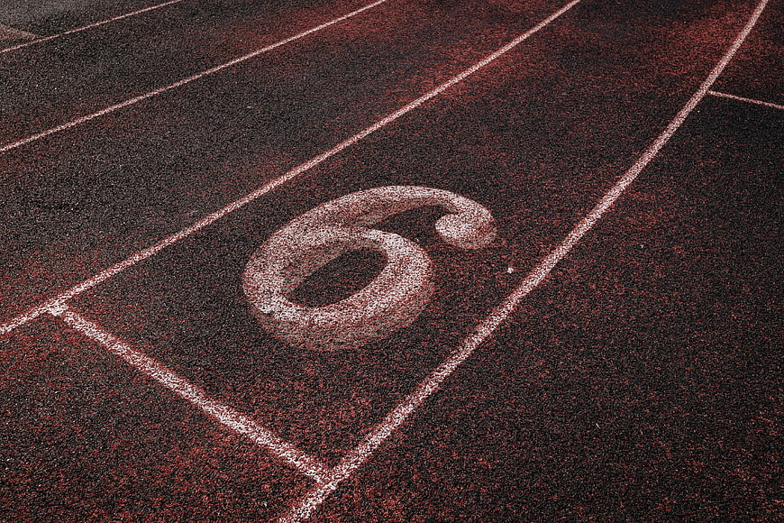 Close-up of number 6 on red running track lane