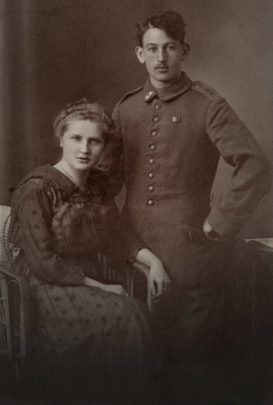 Vintage sepia portrait of a couple, woman seated and man in military uniform