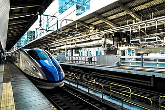 Blue and silver bullet train at urban station platform