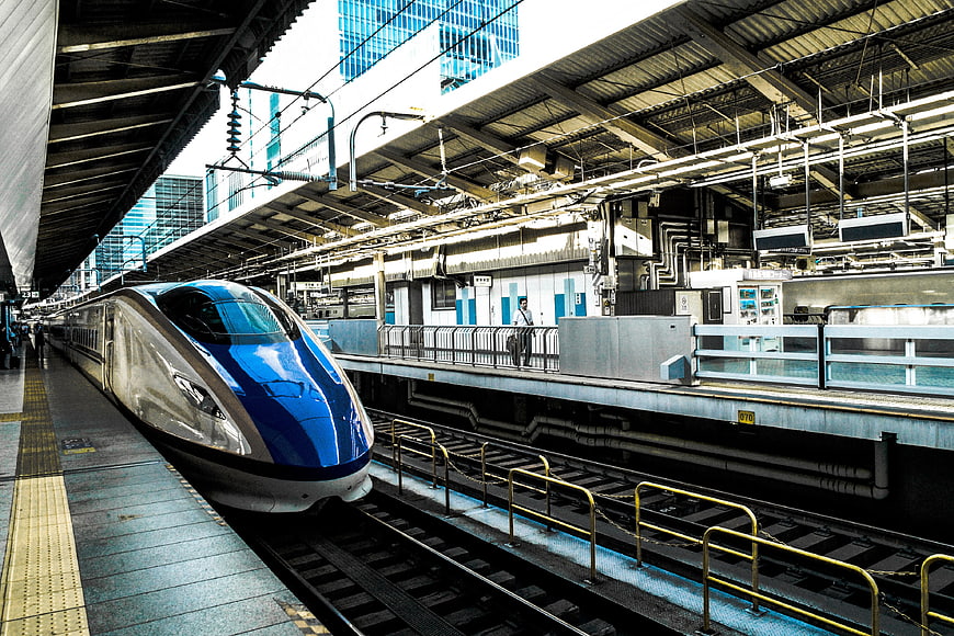 Blue and silver bullet train at urban station platform