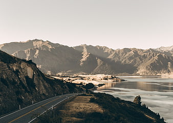Scenic coastal highway winding along rugged mountains and calm ocean