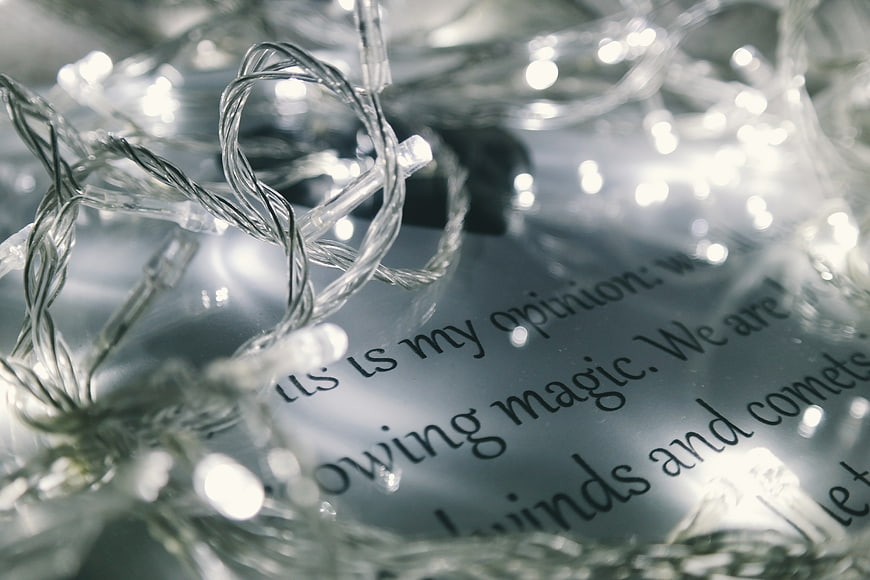 Close-up of Christmas lights on a letter with text
