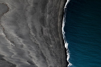 Aerial View of Dark Sand Beach and Blue Ocean Waves