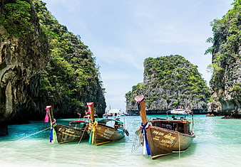 Traditional Thai Longtail Boats in Turquoise Lagoon