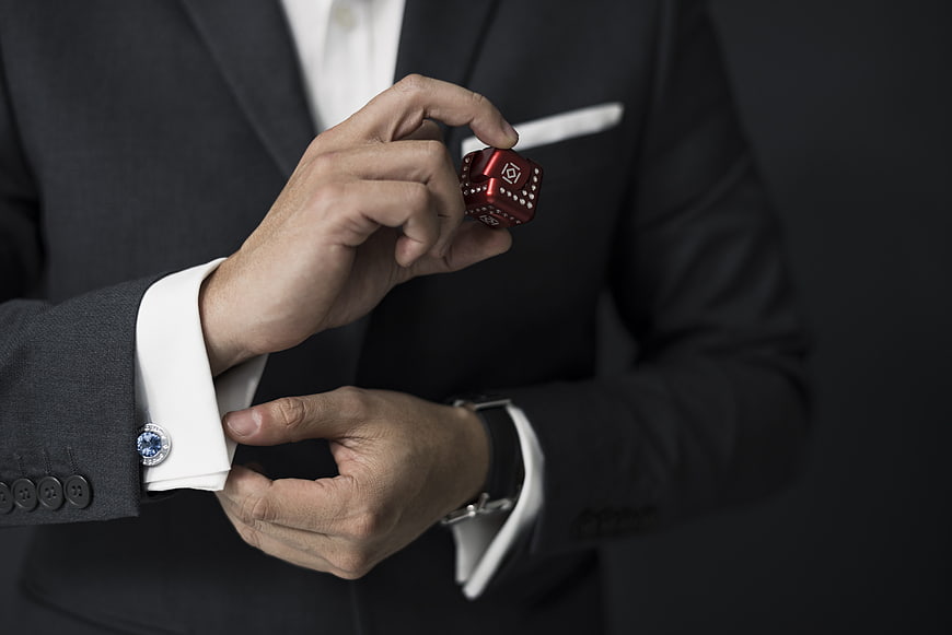 Businessman in Suit Holding Red Fidget Cube