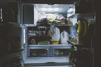 Inside a well-stocked refrigerator with groceries and milk