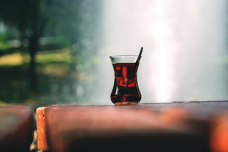 Turkish Tea in Glass Cup on Wooden Table Outdoors