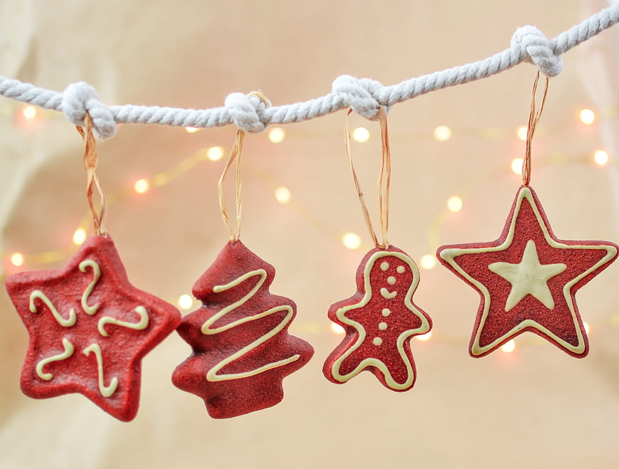 Red Glitter Christmas Ornaments Hanging on Rope with Bokeh Lights