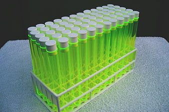 Rack of Test Tubes with Glowing Green Liquid