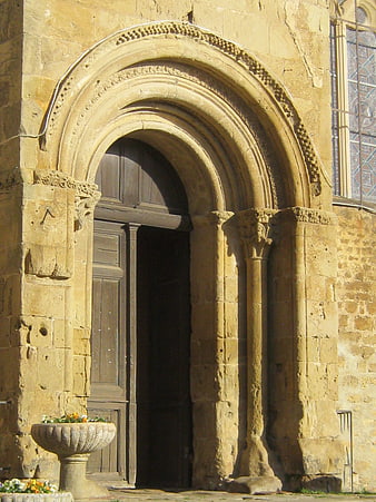 Ancient Romanesque Stone Church Entrance with Arched Doorway