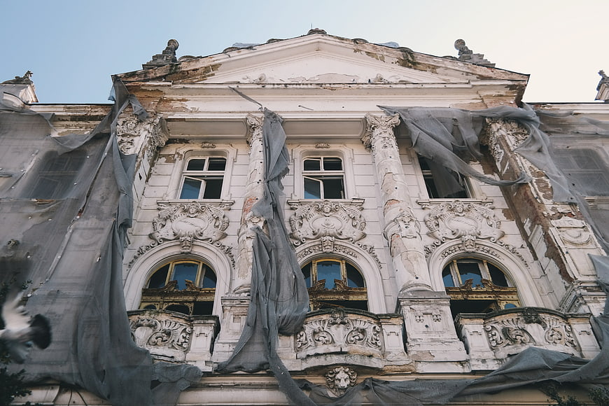 Decaying Baroque Mansion with Tattered Construction Netting