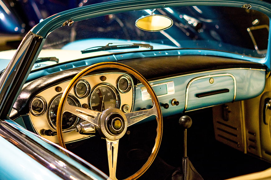 Vintage turquoise classic car interior with wooden steering wheel