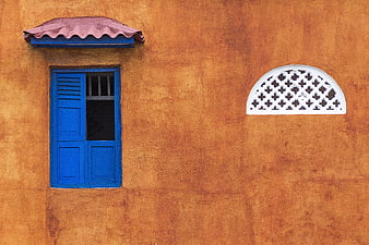 Blue Window and White Lattice on Orange Wall