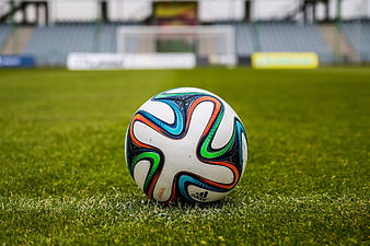 Colorful Adidas Soccer Ball on Green Grass Field