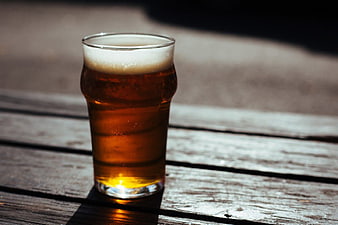 Glass of Amber Beer on Rustic Wooden Table