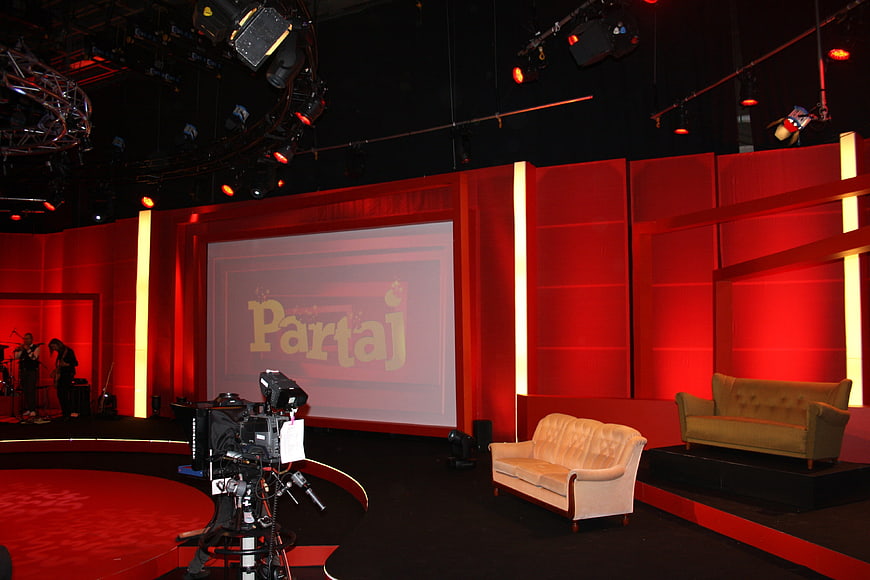 Red television studio set with camera and sofas
