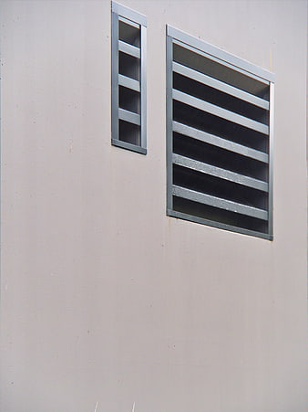 Minimalist architectural detail of gray wall vents