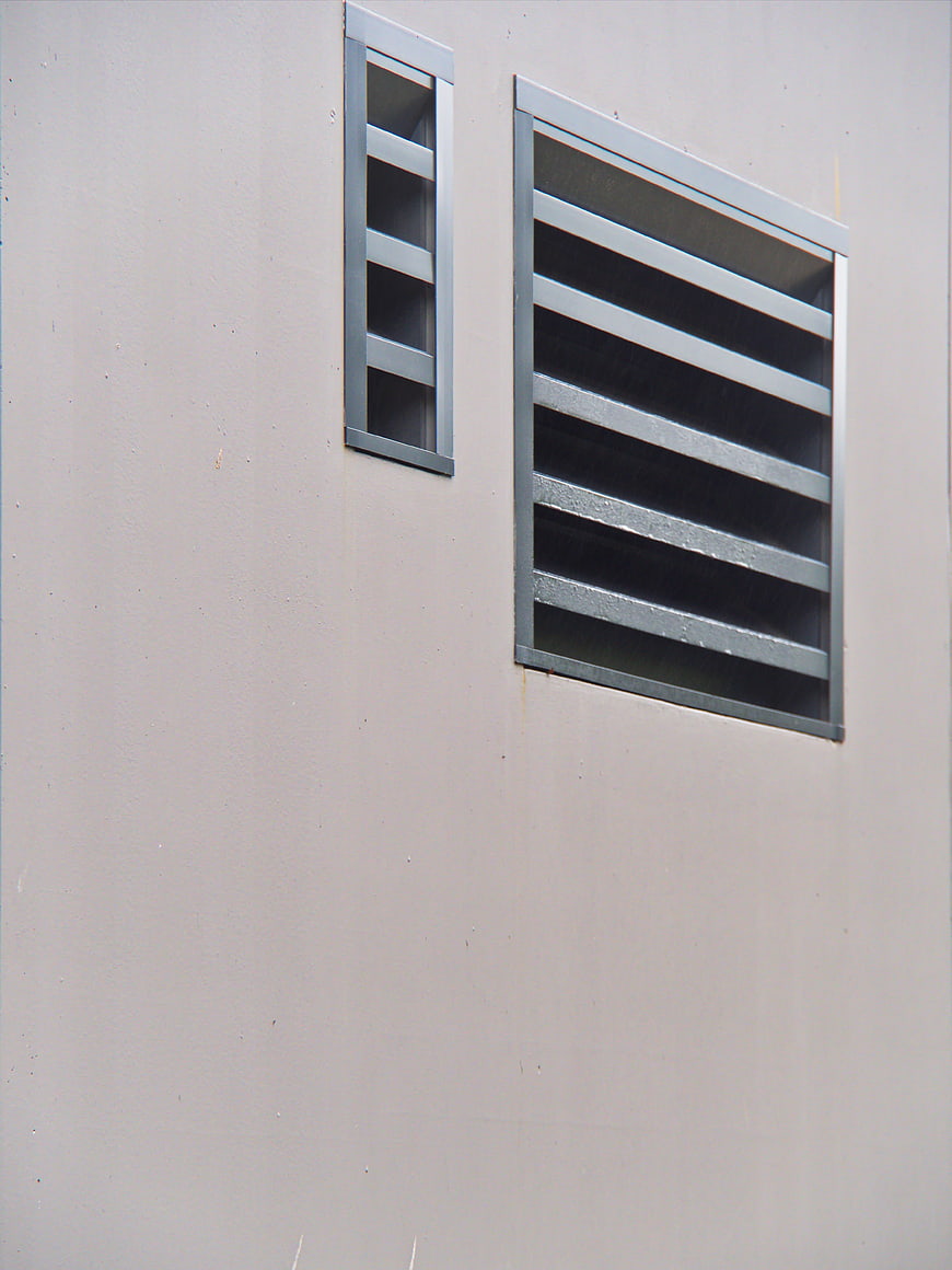 Minimalist architectural detail of gray wall vents