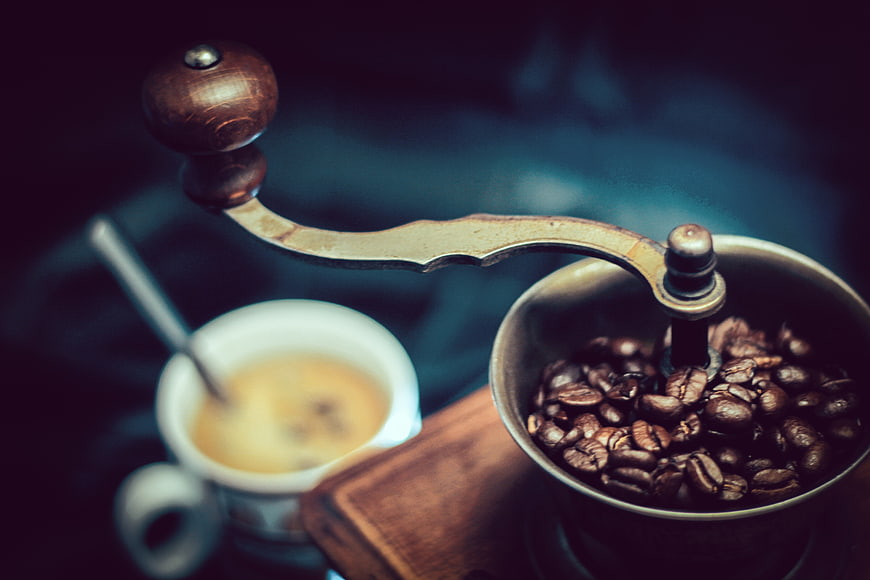 Vintage Manual Coffee Grinder with Beans and Espresso Cup